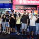 Demonstrators hold their hands to their eyes in solidarity with a woman who suffered a serious eye injury at a previous protest.